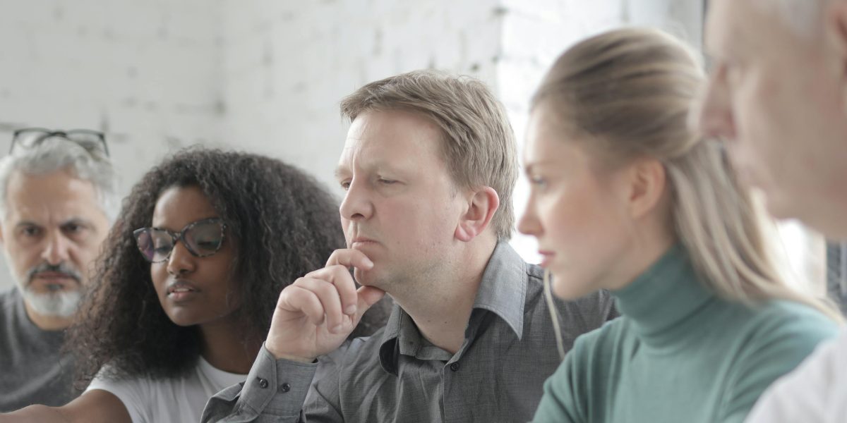 A person deeply concentrated, actively engaging their mind in a challenging task.