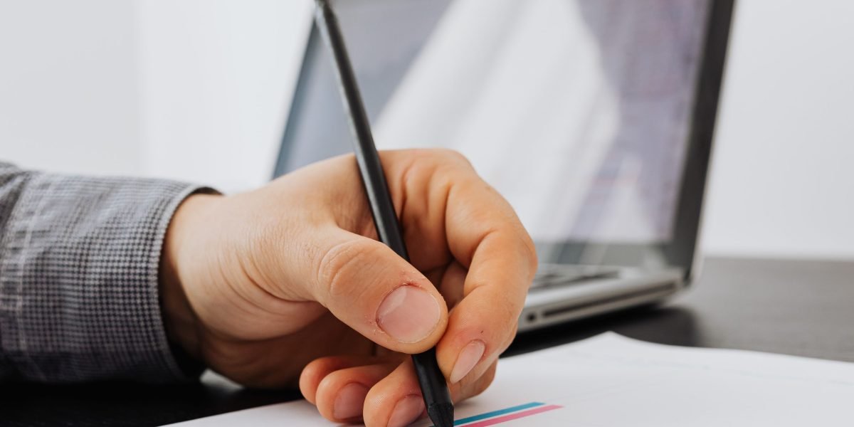 A person reviewing charts or notes, tracking their personal progress and achievements.