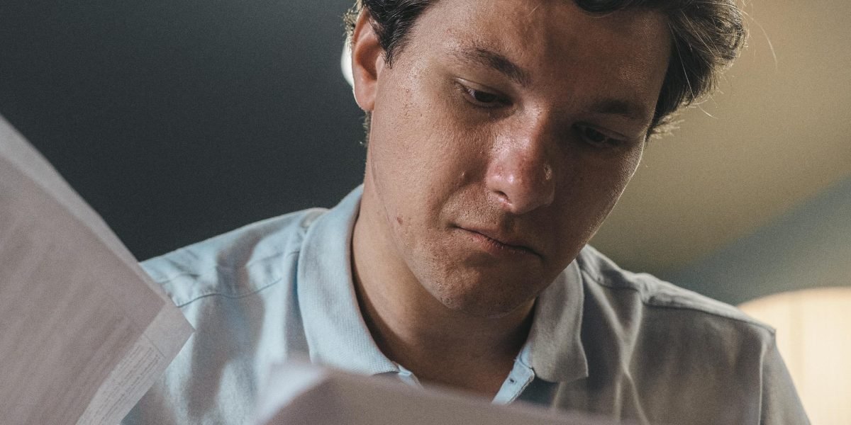 A person intently reviewing documents, symbolizing the scientific investigation of brain games.