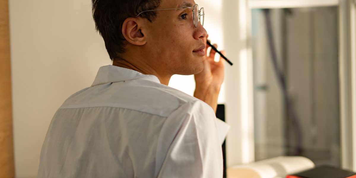 A person engrossed in deep thought, perhaps contemplating complex decisions or future moves, symbolizing the mental effort in strategy games.