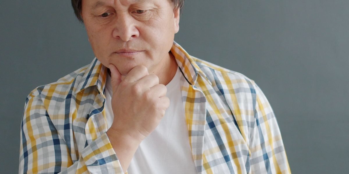 A person engaged in thoughtful reflection, symbolizing the cognitive challenges of daily life.