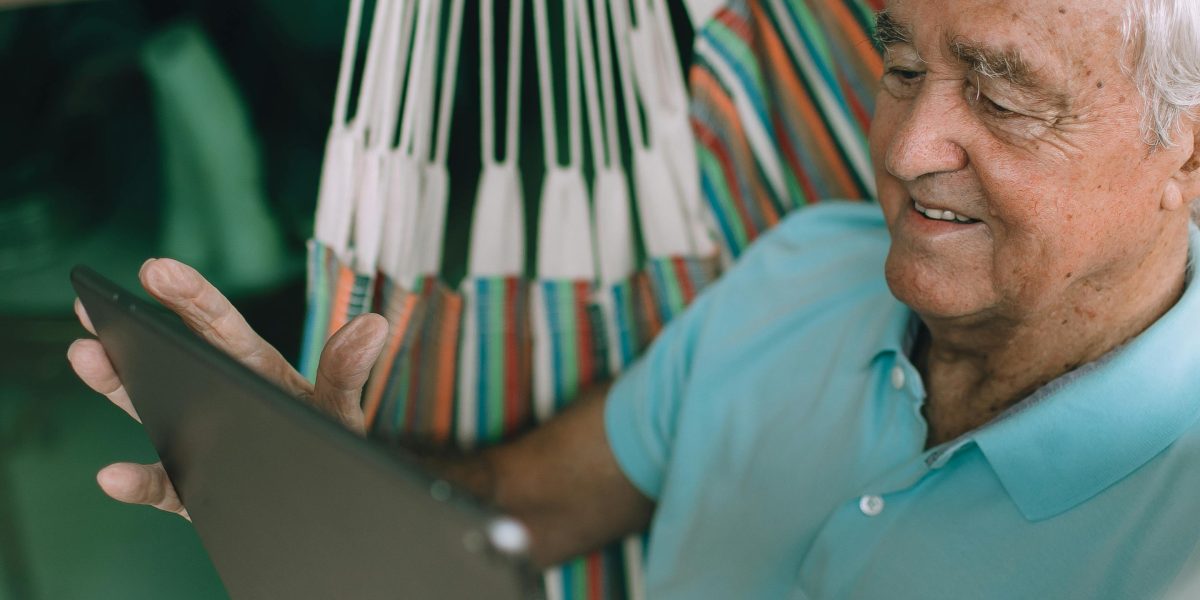 An older person comfortably interacting with a digital device, highlighting user accessibility.