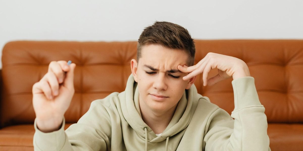 A person looking thoughtful or slightly frustrated, perhaps trying to recall something or concentrate.