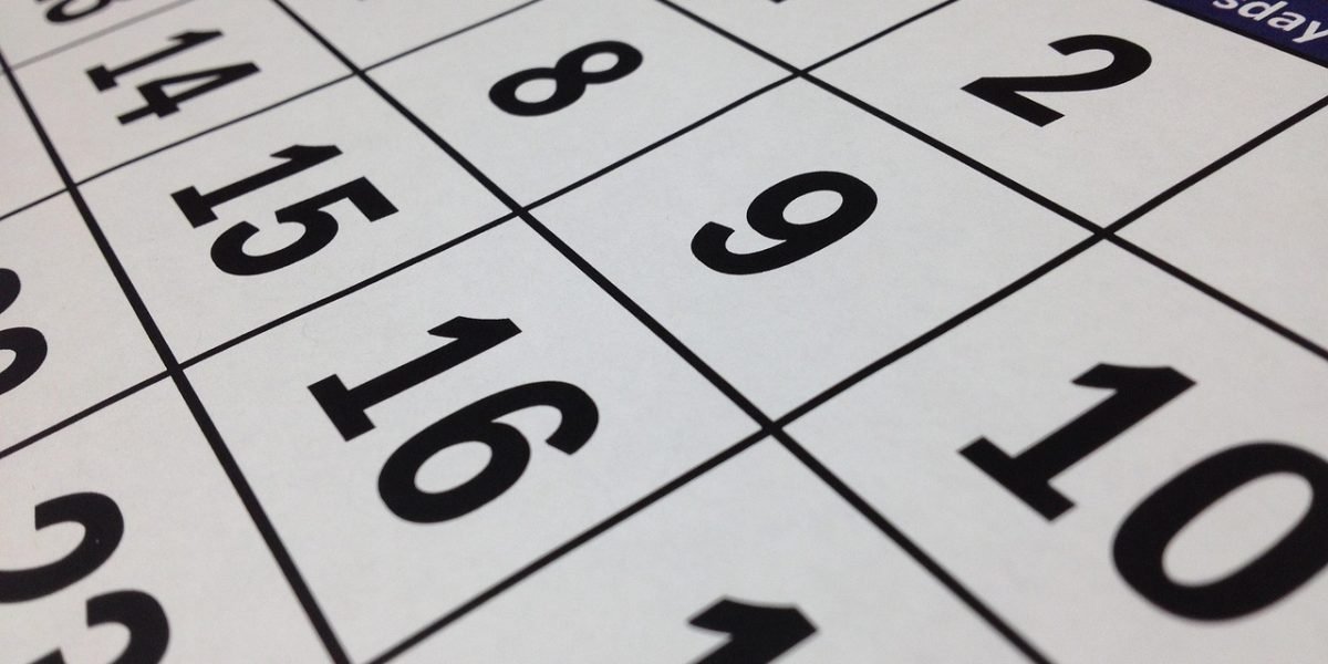 Someone organizing their schedule or planning tasks, representing structured effort and consistency.
