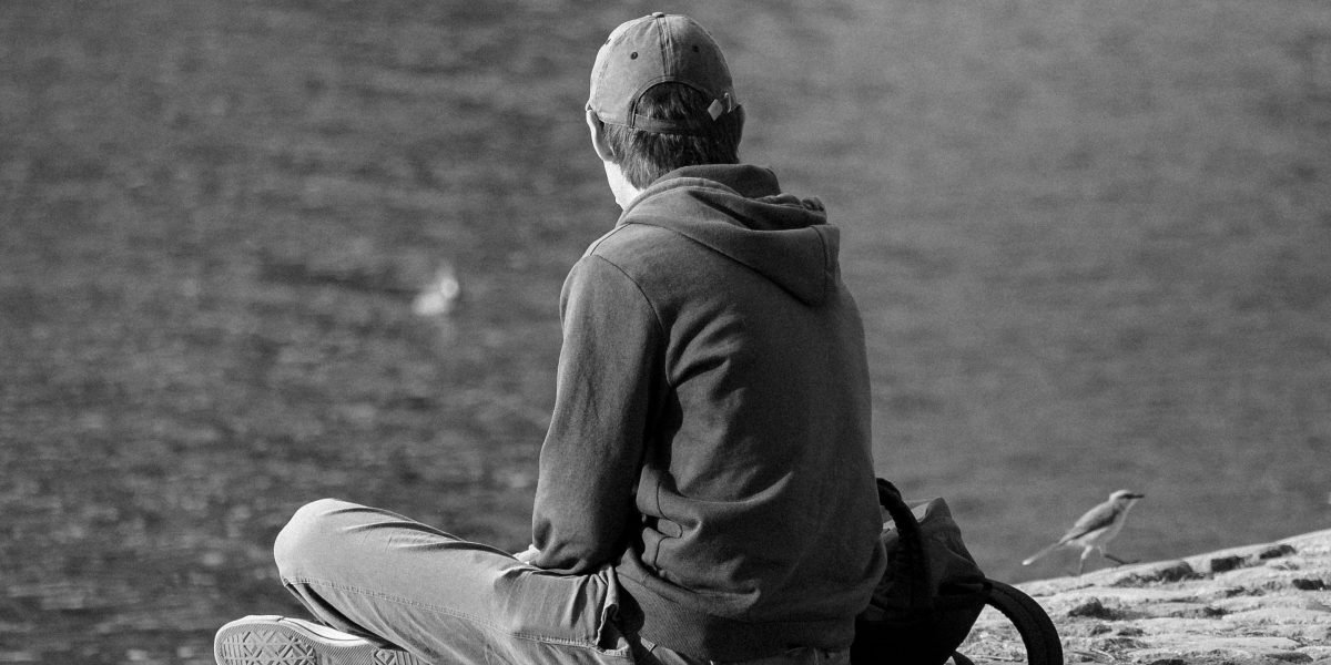 A person sitting calmly, reflecting on life and contemplating the future with a peaceful expression.