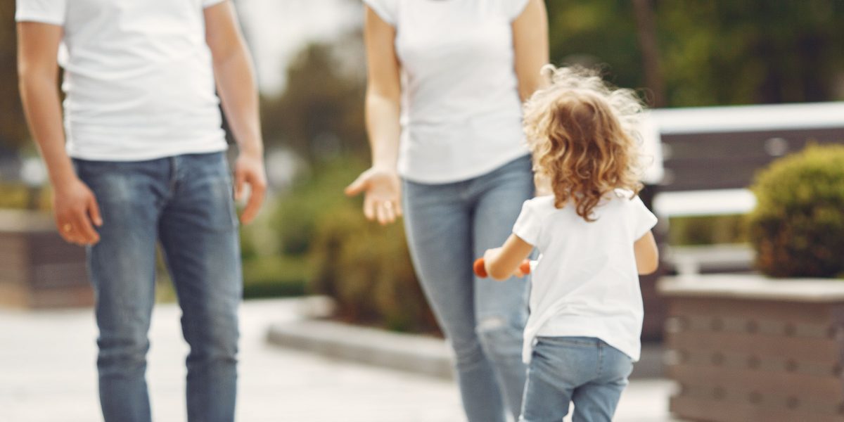 A parent thoughtfully selecting educational resources for their child's development.