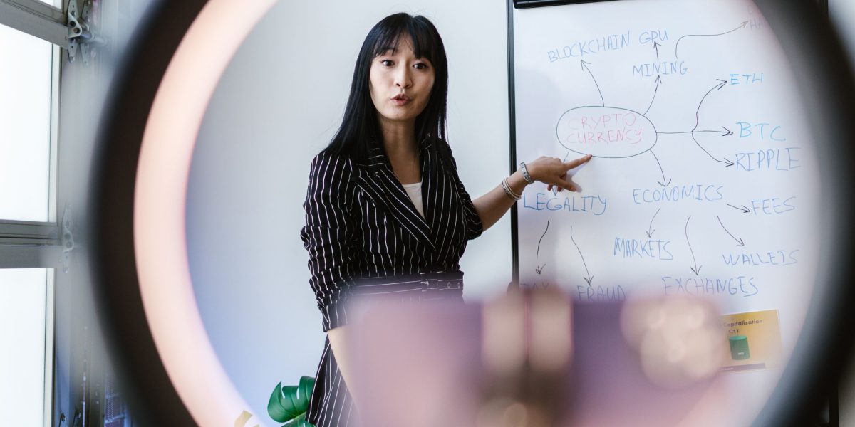 A professional explaining a complex idea on a whiteboard, demonstrating integrated thinking.