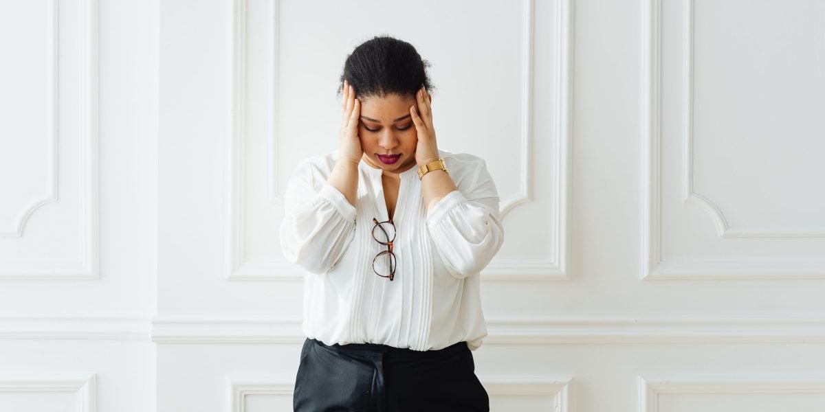 A person looking overwhelmed, symbolizing the challenges of cognitive pitfalls like information overload.