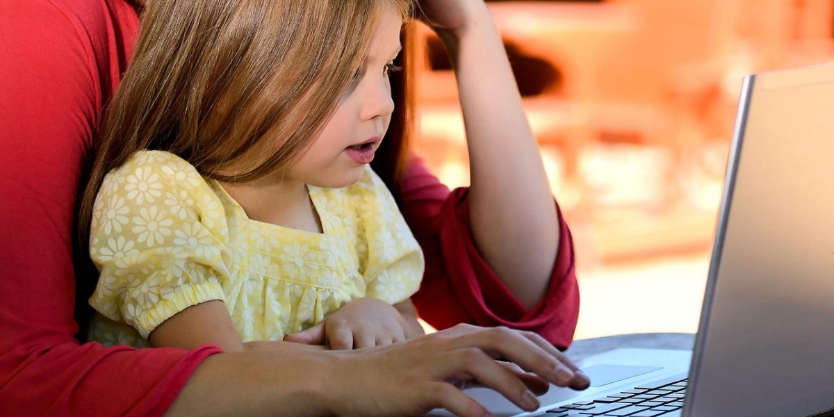A parent and child engaging in a discussion, fostering reflection and connecting gameplay to learning.