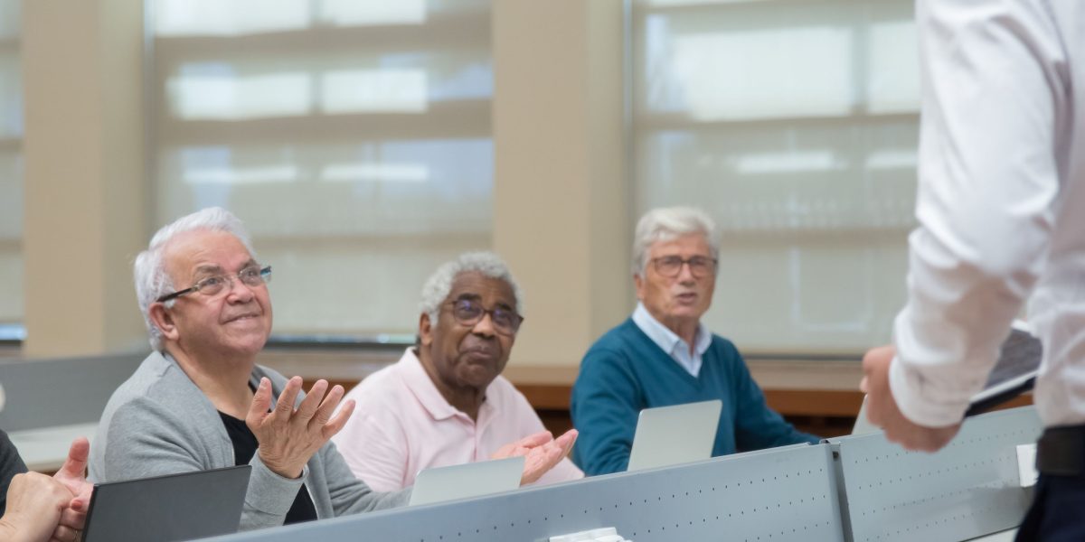 An older adult actively participating in a mentally stimulating activity, representing cognitive engagement throughout life.