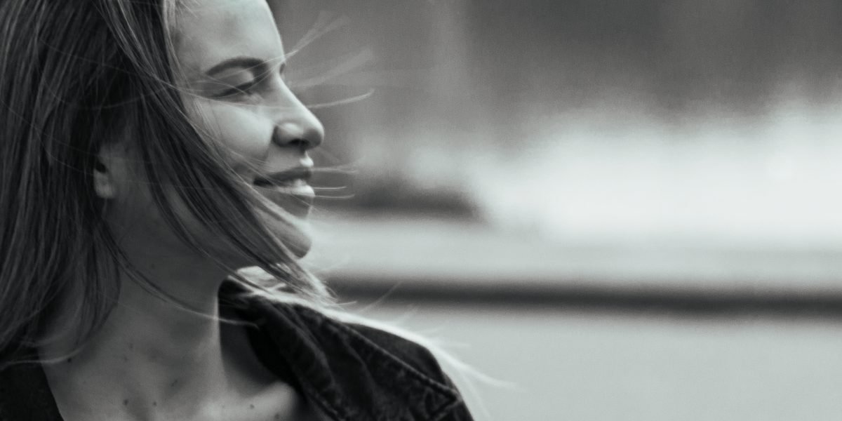 A person smiling confidently, having successfully recalled a piece of information, illustrating improved memory.
