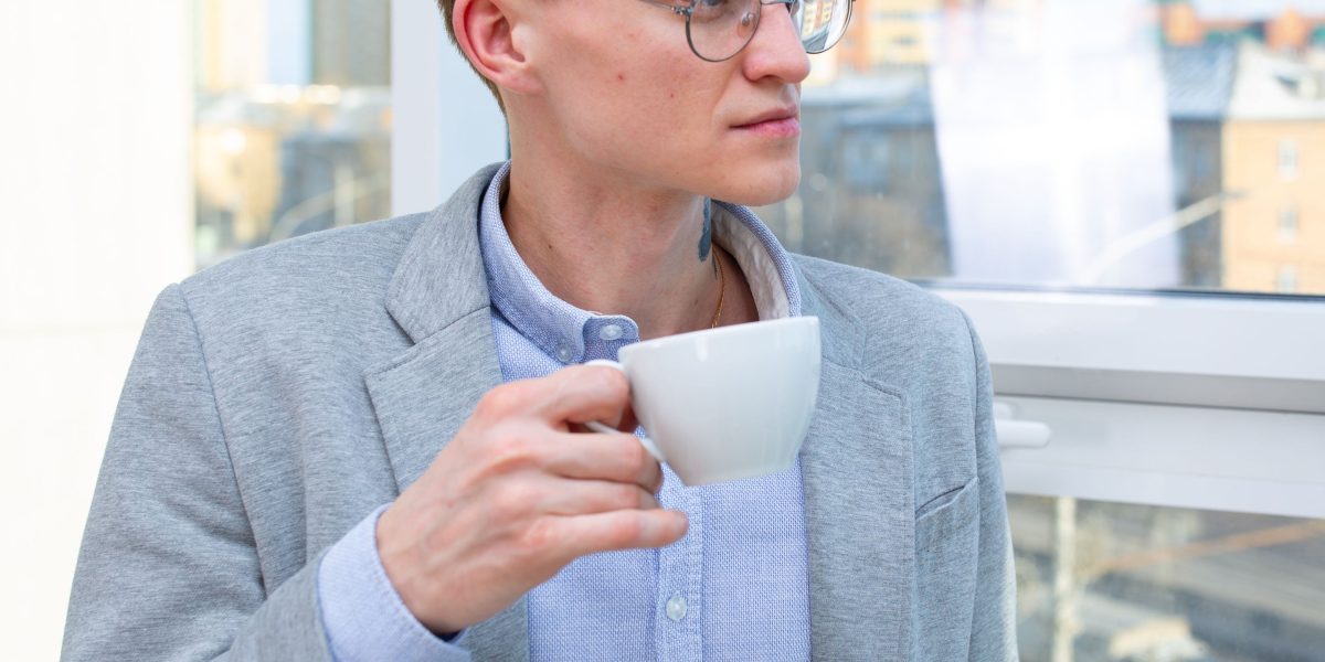 A professional taking a mindful break during work, possibly engaging in a quick mental exercise.