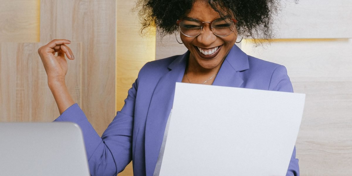 A person confidently reviewing notes or a tracker, showing a sense of accomplishment.