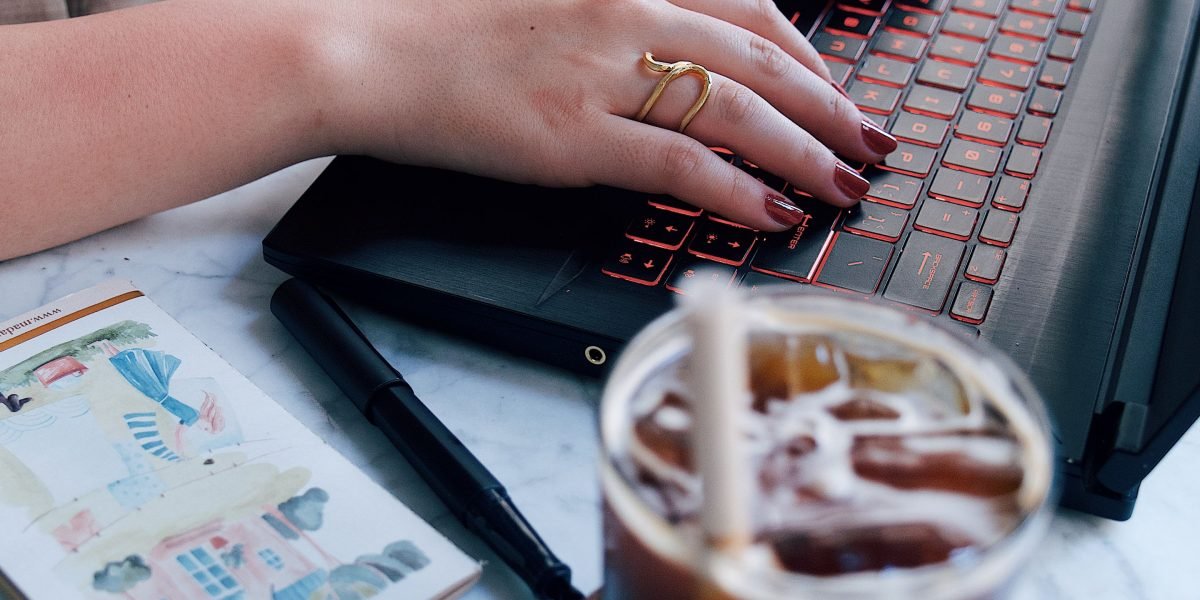A person typing on a keyboard, illustrating the procedural memory involved in motor skills performed without conscious effort.