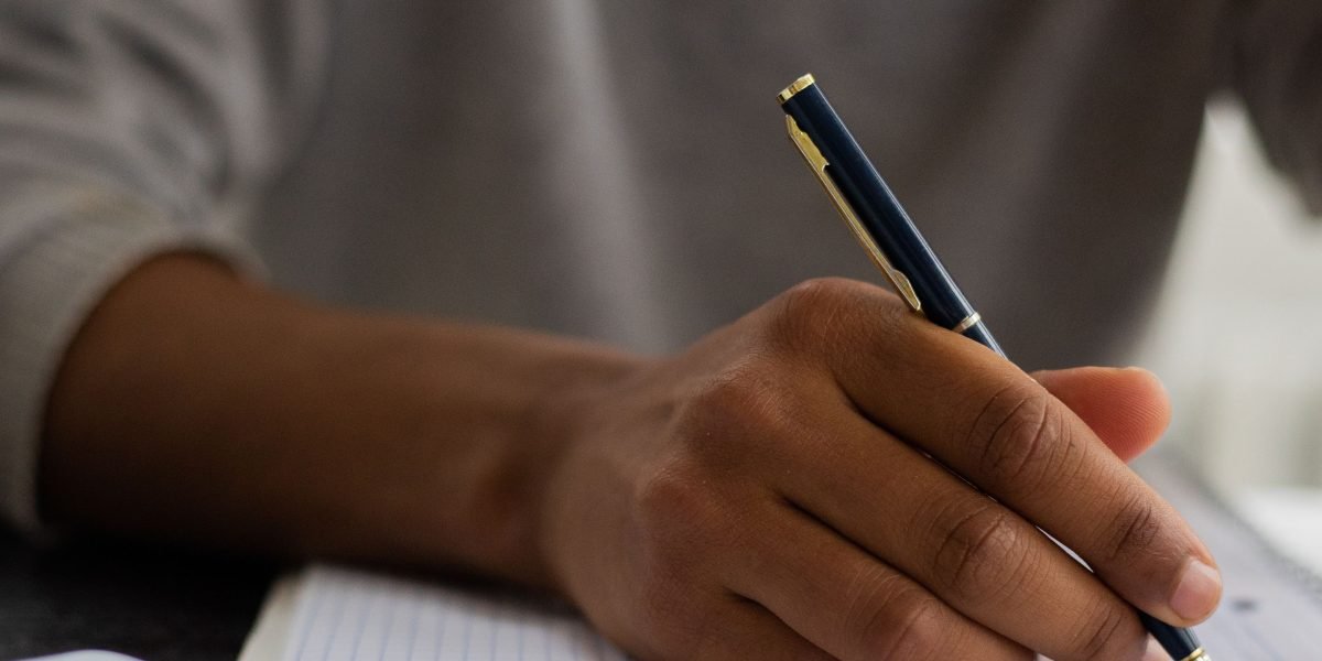 A person actively taking notes and studying, demonstrating effective strategies for boosting semantic memory.